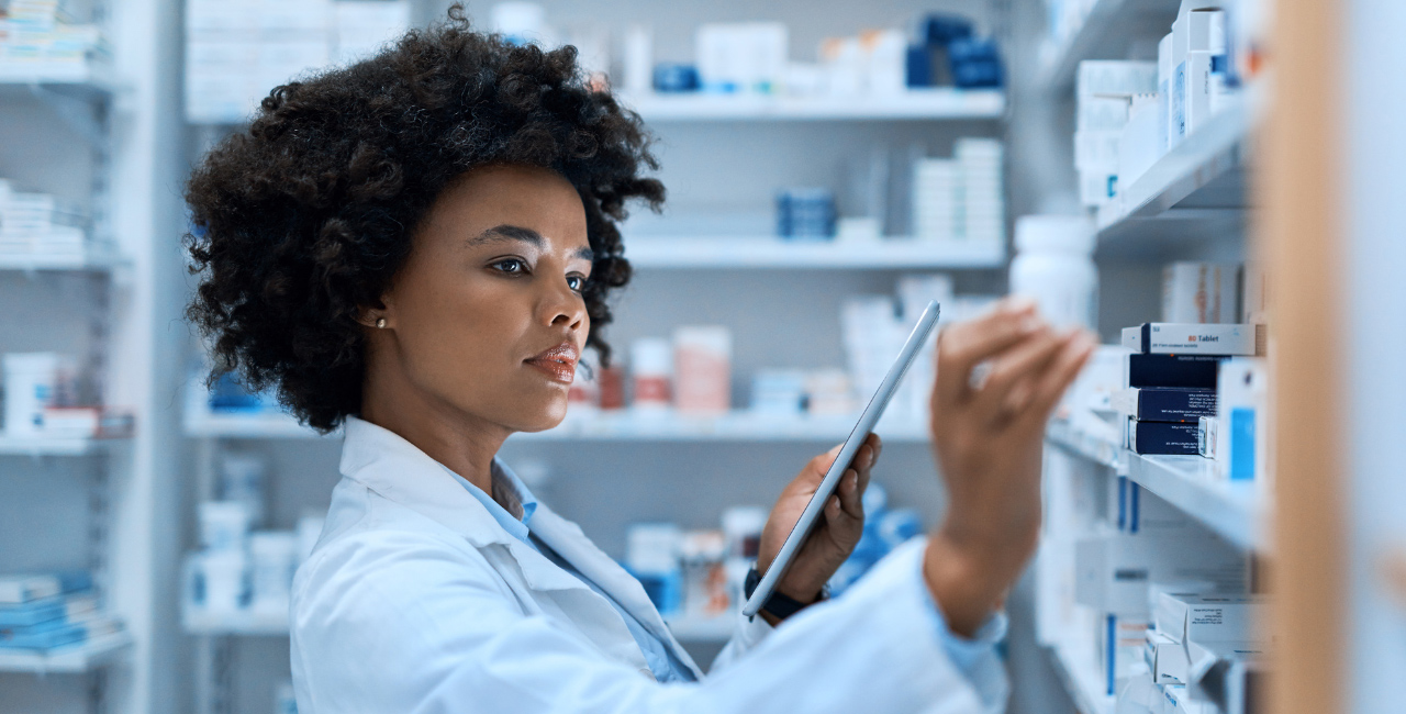 A pharmacist getting medication from a shelf